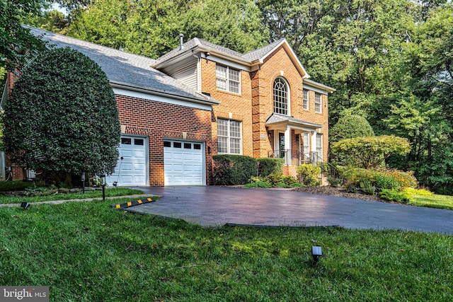 view of front of property with a garage and a front yard