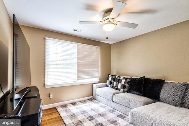 living room with ceiling fan and light wood-type flooring