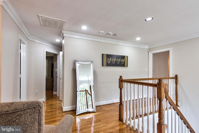 hall featuring crown molding and light hardwood / wood-style flooring