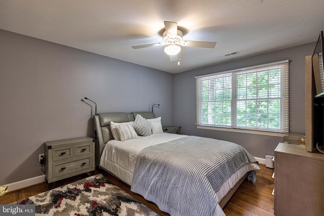 bedroom with ceiling fan and dark hardwood / wood-style flooring