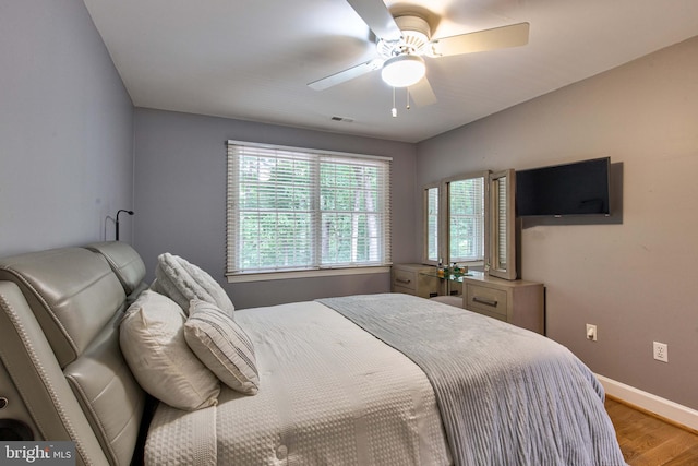 bedroom with ceiling fan and hardwood / wood-style floors