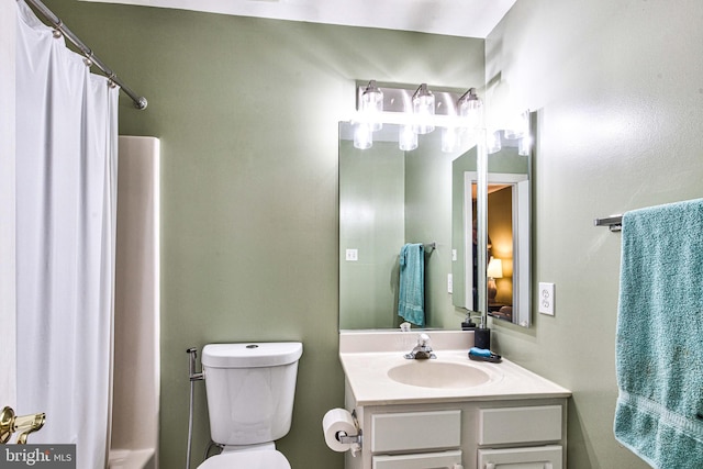 bathroom featuring vanity, toilet, and a shower with shower curtain