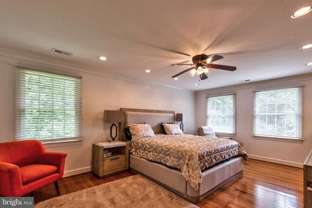 bedroom with ornamental molding and wood-type flooring