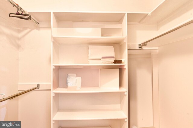 bedroom featuring ensuite bath, light hardwood / wood-style flooring, and ornamental molding