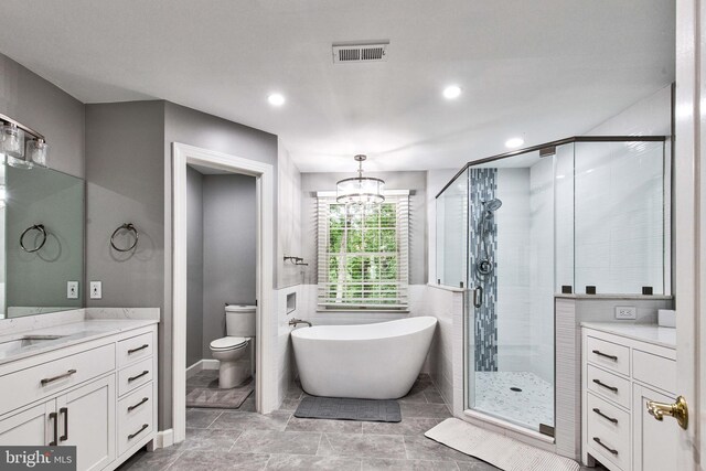 bathroom with vanity, a chandelier, plus walk in shower, and a healthy amount of sunlight