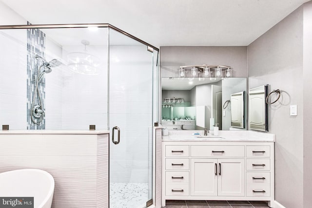 bathroom with shower with separate bathtub and vanity