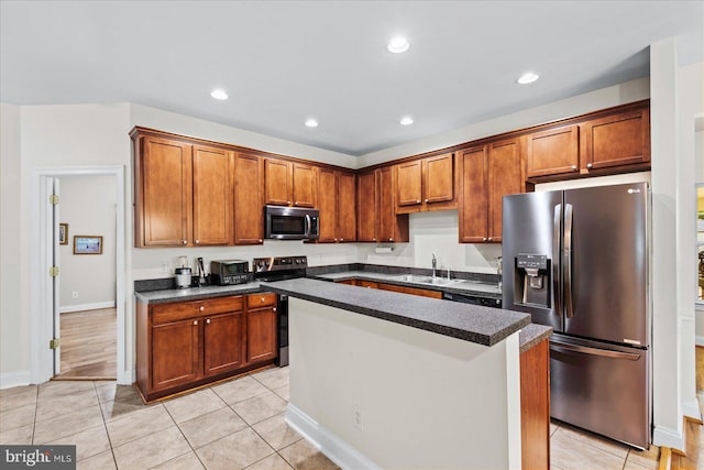 kitchen featuring light tile patterned flooring, a kitchen island, sink, and stainless steel appliances