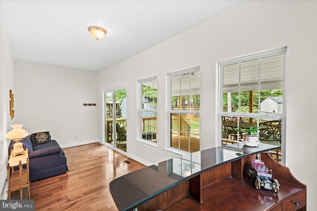 office area with light hardwood / wood-style flooring and plenty of natural light