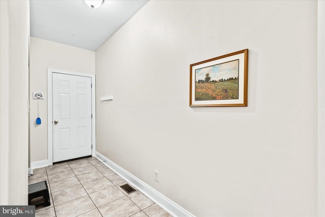 doorway with light tile patterned flooring