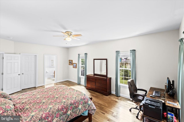 bedroom with ceiling fan, ensuite bathroom, and light hardwood / wood-style flooring