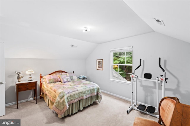 bedroom with light colored carpet and lofted ceiling