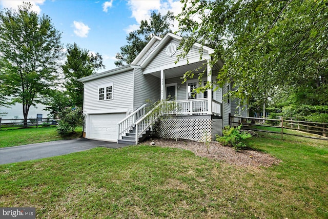 view of front of house with a garage, a porch, and a front lawn