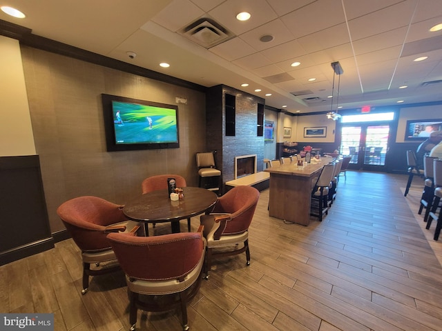 dining area with a fireplace and light hardwood / wood-style flooring