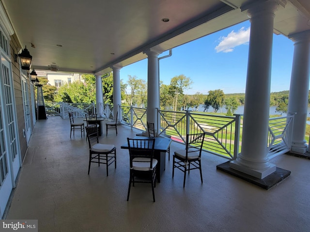 view of patio with a water view