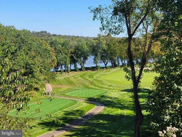 surrounding community with a lawn and a water view