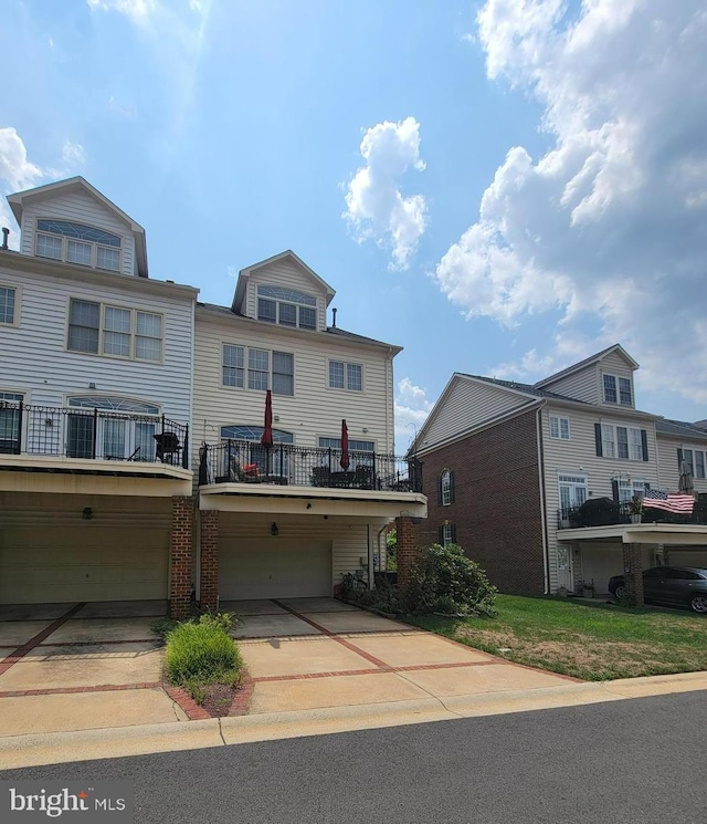 townhome / multi-family property featuring a garage and a balcony