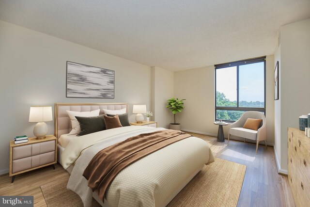 bedroom featuring light wood-style floors and baseboards