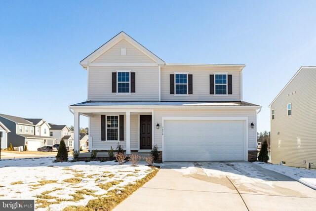 view of front of home with a front yard, a garage, and a porch