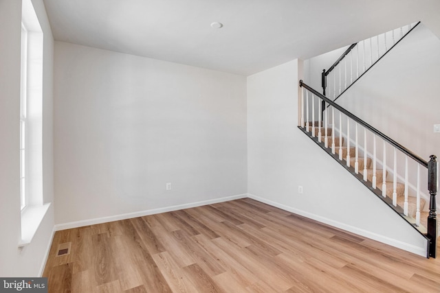 empty room featuring light wood-type flooring and plenty of natural light