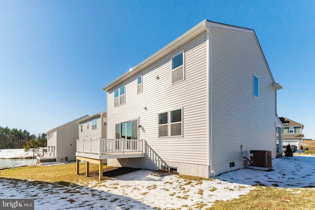 rear view of house featuring central air condition unit and a wooden deck