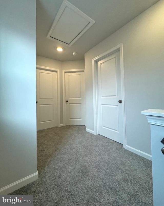 unfurnished room with dark carpet