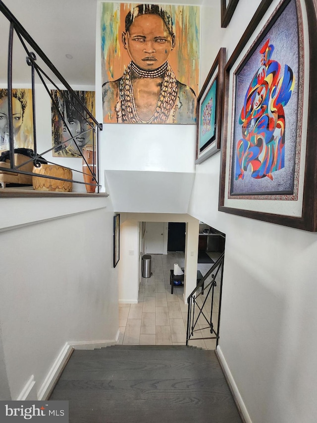 staircase featuring tile patterned flooring