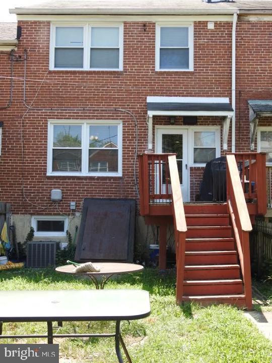 back of house featuring cooling unit