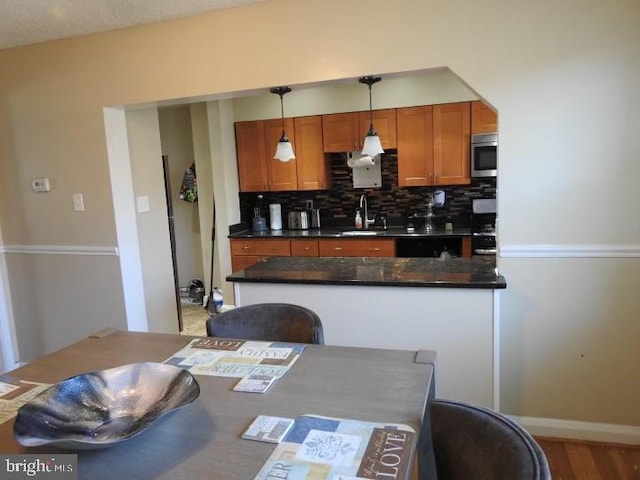 kitchen featuring pendant lighting, sink, and decorative backsplash