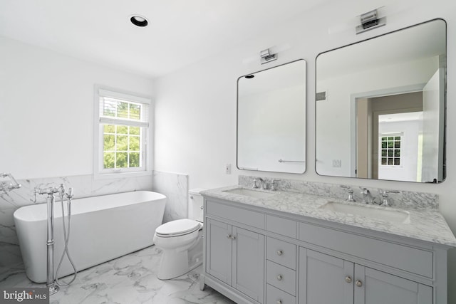 bathroom featuring dual vanity, tile patterned floors, tile walls, a bathtub, and toilet