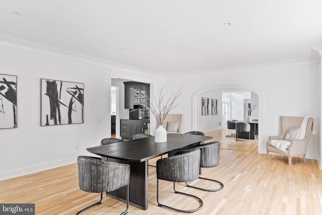 dining room featuring light hardwood / wood-style flooring and ornamental molding