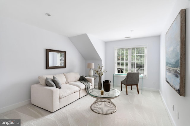 carpeted living room with lofted ceiling