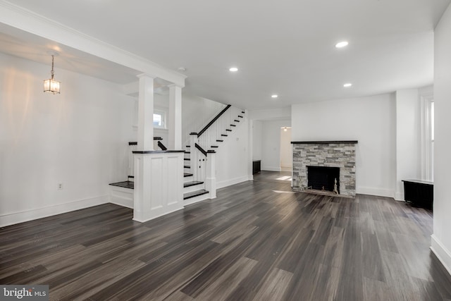 unfurnished living room with recessed lighting, dark wood-type flooring, a fireplace, baseboards, and stairway