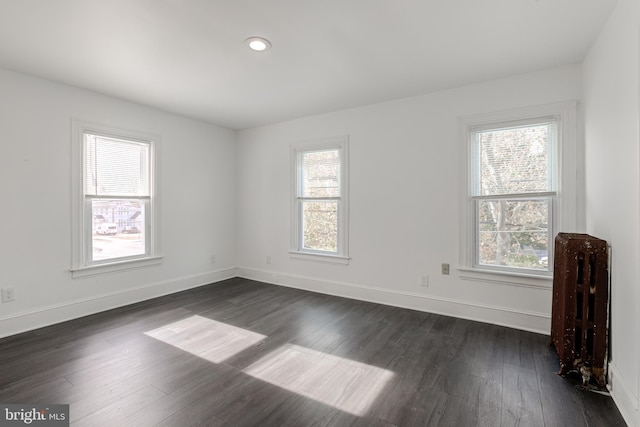 spare room featuring dark hardwood / wood-style flooring