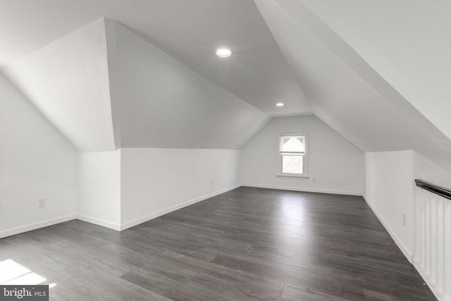 bonus room featuring dark hardwood / wood-style flooring and vaulted ceiling