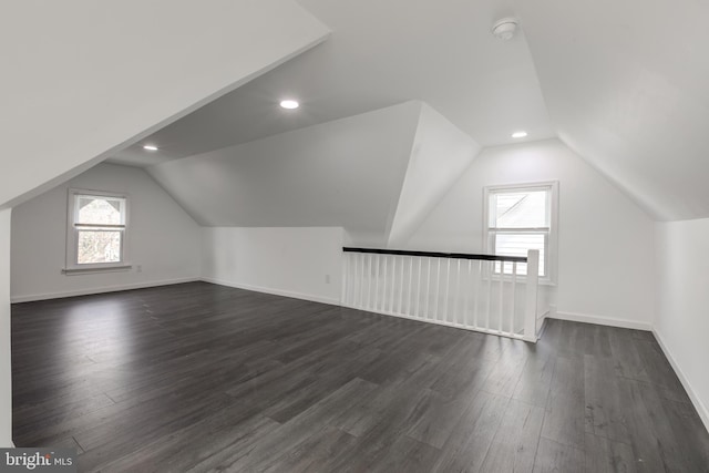 bonus room featuring vaulted ceiling and dark wood-type flooring