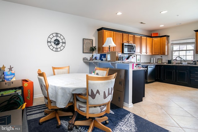 dining space featuring light tile patterned flooring and sink