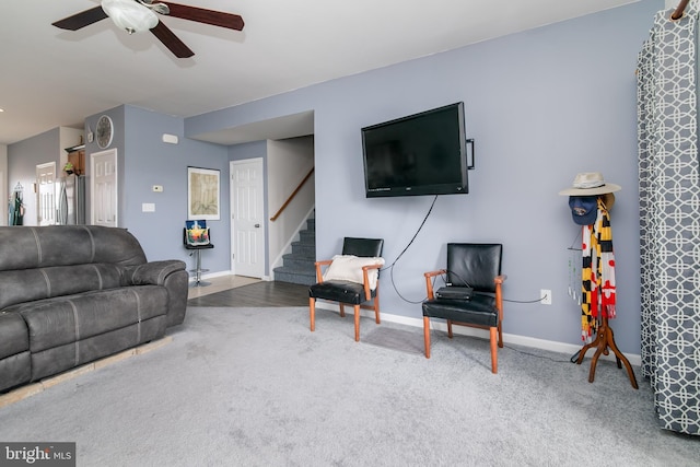 living room with ceiling fan and carpet flooring