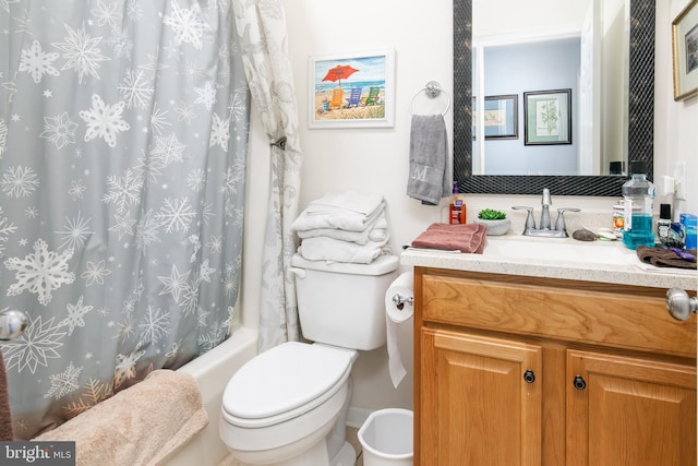 full bathroom featuring vanity, shower / bath combo with shower curtain, and toilet