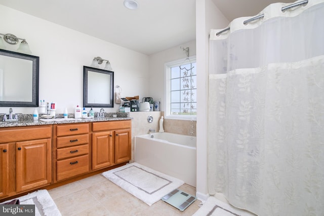 bathroom with tile patterned floors, vanity, and a tub