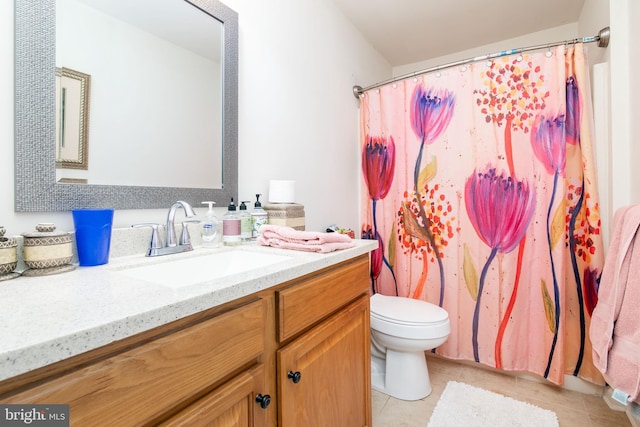 bathroom featuring vanity, toilet, and tile patterned flooring