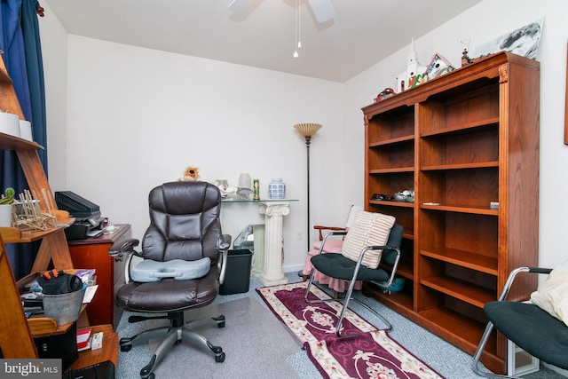 carpeted home office featuring ceiling fan