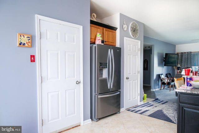 kitchen with light tile patterned floors and stainless steel fridge with ice dispenser