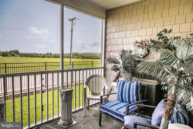 sunroom featuring a rural view