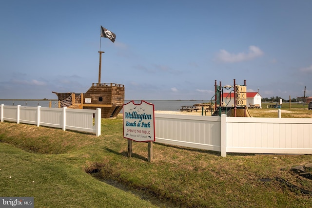 exterior space with a yard, a playground, and a water view