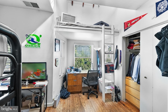 home office with light hardwood / wood-style floors