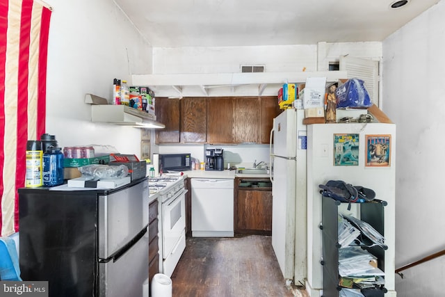 kitchen featuring sink, white appliances, and dark wood-type flooring