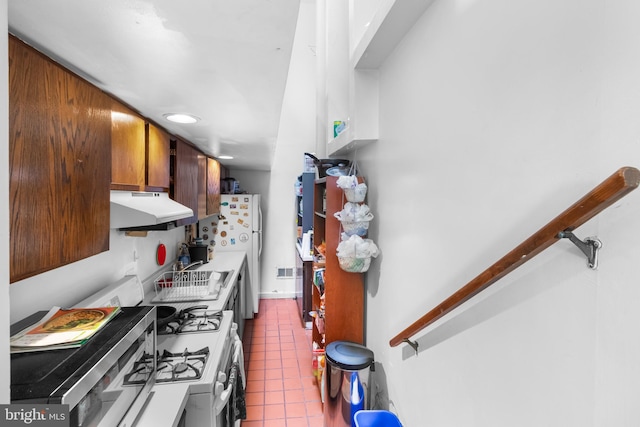 kitchen with tile patterned floors, sink, and range with gas cooktop