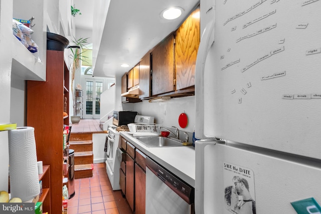 kitchen with light tile patterned flooring, sink, and white appliances