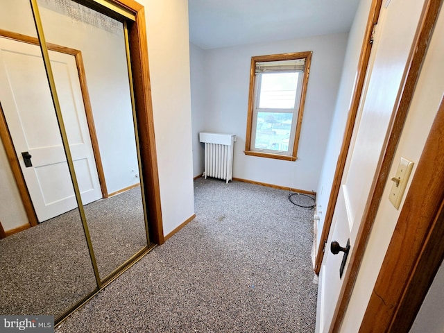 hallway with radiator and carpet