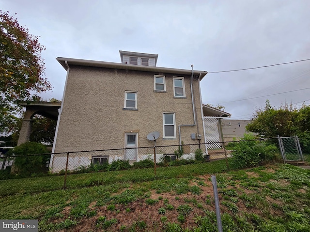 view of property exterior with a lawn